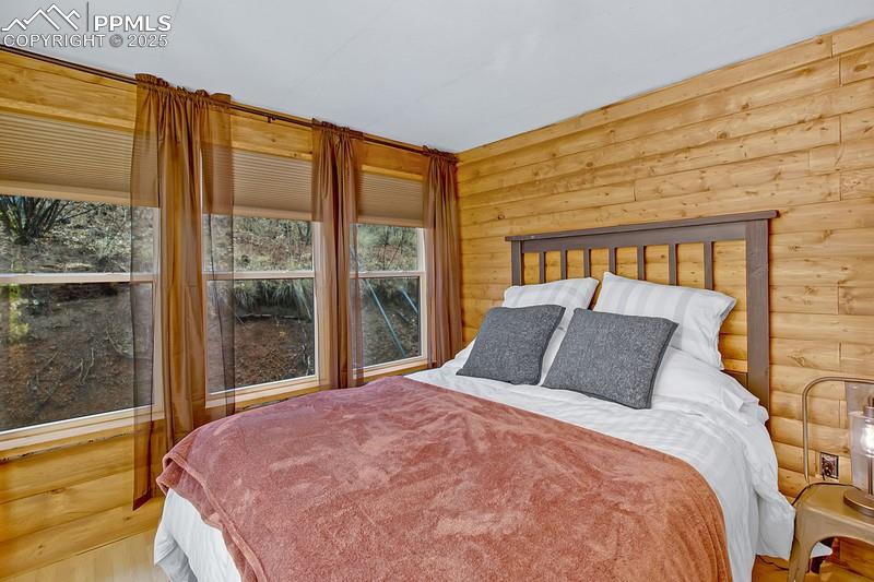 361 Willow Road Divide, CO 80814 - Photo 22 of 27 a bedroom with a large bed and a large window