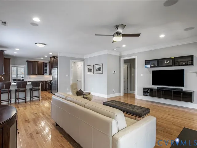 a living room with furniture a clock and a fireplace