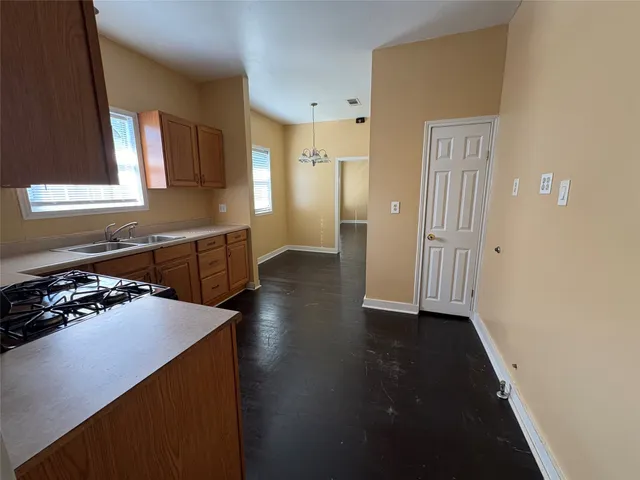 a kitchen with a sink a stove and cabinets