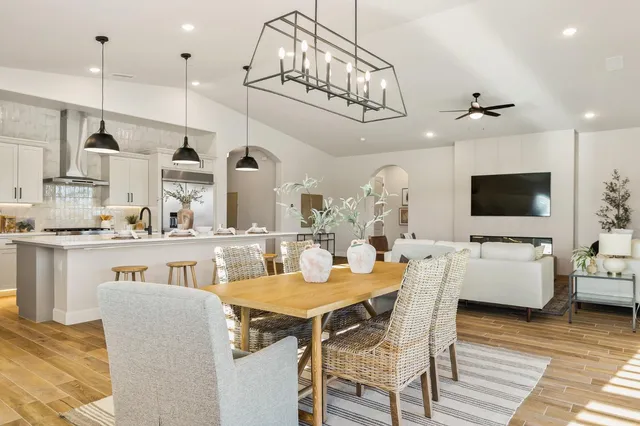 a living room with furniture wooden floor and a chandelier