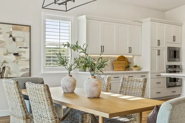 a living room with lots of furniture and kitchen view