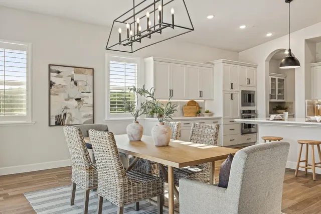 a living room with lots of furniture and kitchen view