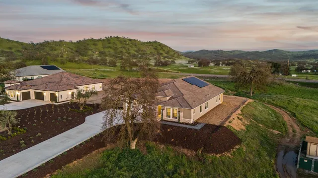 a view of a hallway with wooden floor and a living room