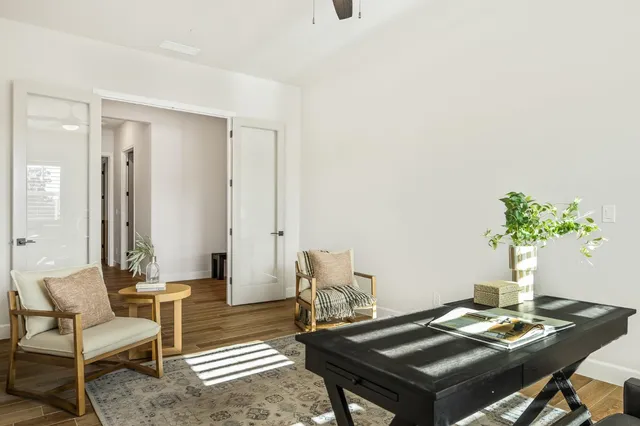 a view of a room with wooden floor and white walls