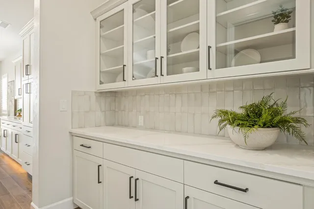 a spacious bathroom with a double vanity sink a large mirror and a bathtub