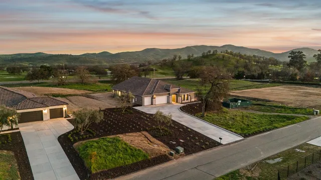 a kitchen with kitchen island granite countertop a sink a stove and refrigerator