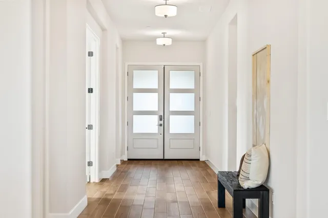 a kitchen with stainless steel appliances granite countertop a sink a stove and chairs