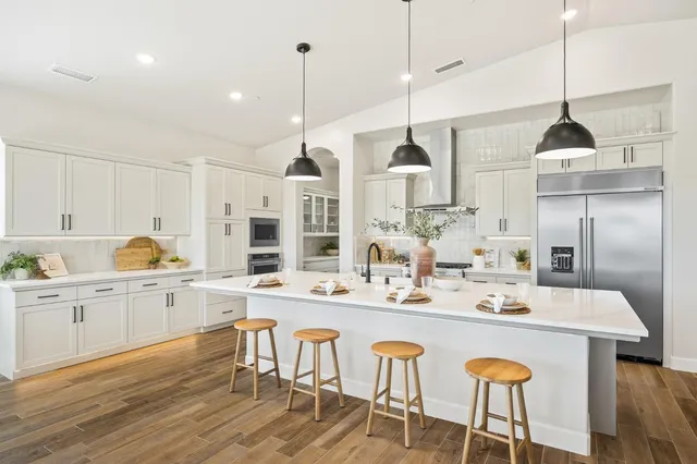 a kitchen with a table and chairs