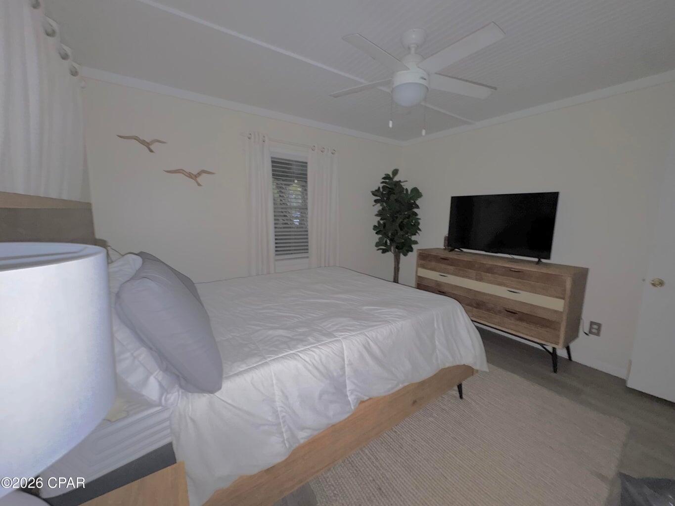 181 Gulf Point Road Santa Rosa Beach, FL 32459 - Photo 12 of 18 a bedroom with a bed and a flat screen tv