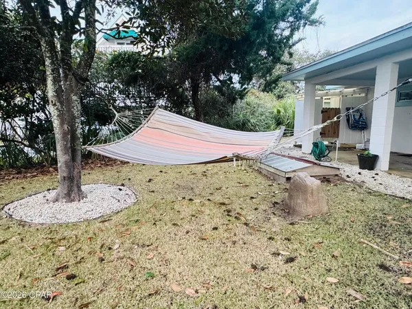 a table and chairs in a backyard of the house