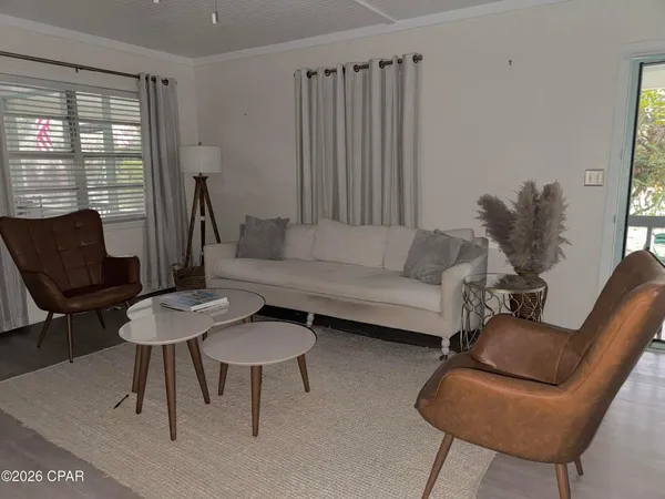 a living room with furniture and a large window