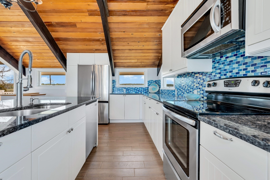90 Salt Marsh Road East Sandwich, MA 02537 - Photo 15 of 40 a kitchen with stainless steel appliances granite countertop a sink and a stove