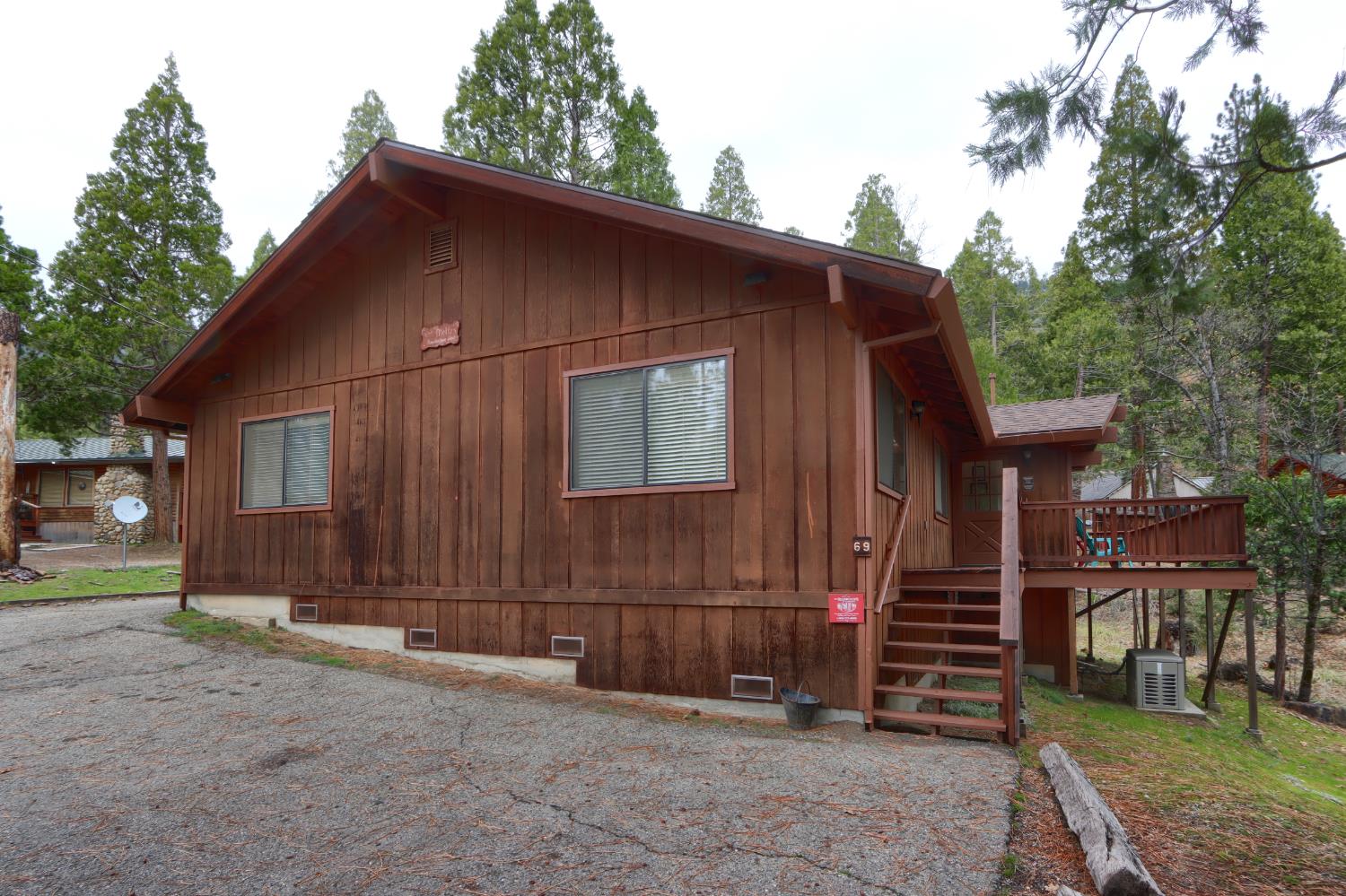 8041 Chilnualna Falls Road Wawona, CA 95389 - Photo 38 of 46 a backyard of a house with barbeque oven and trees