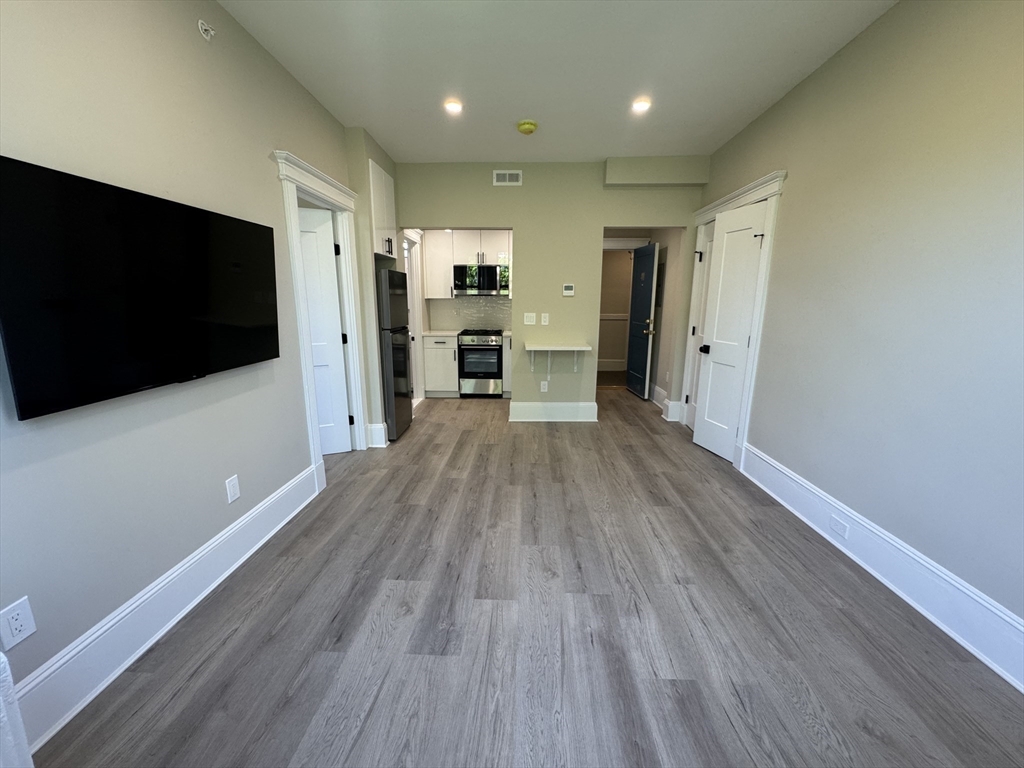 41 Edgerly Road, Unit 28 Boston, MA 02115 - Photo 2 of 13 a view of a kitchen with a sink and a refrigerator