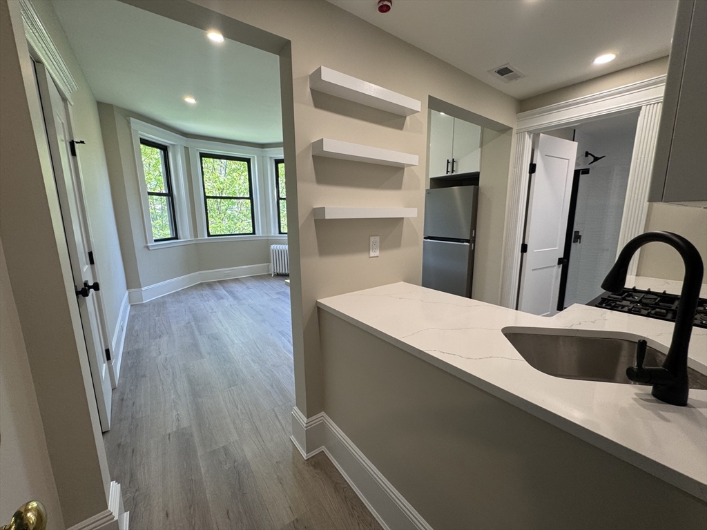 41 Edgerly Road, Unit 28 Boston, MA 02115 - Photo 5 of 13 a kitchen with stainless steel appliances a refrigerator and a sink