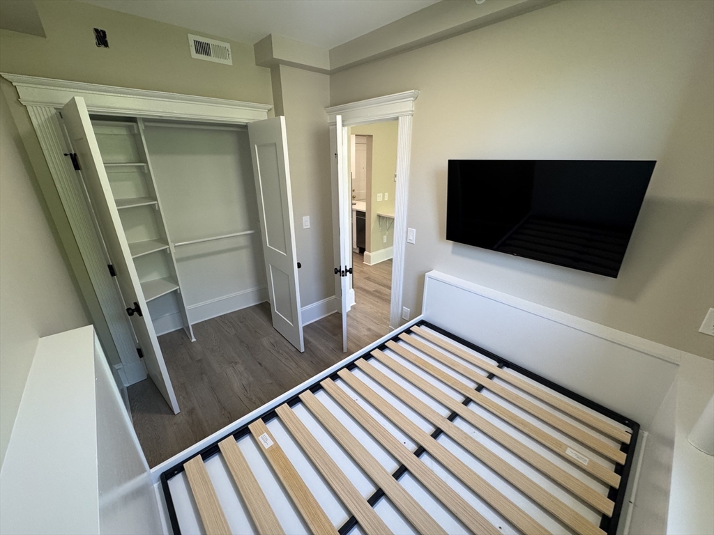 41 Edgerly Road, Unit 28 Boston, MA 02115 - Photo 7 of 13 a living room with chairs and a flat screen tv