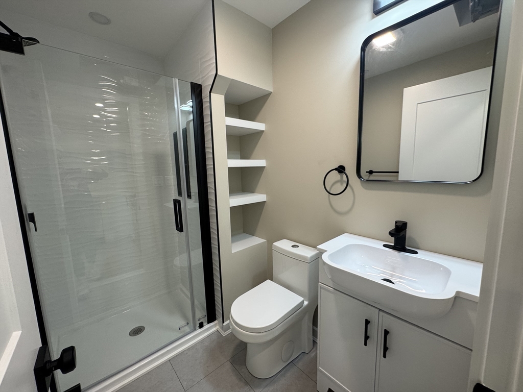 41 Edgerly Road, Unit 28 Boston, MA 02115 - Photo 10 of 13 a bathroom with a toilet sink and shower