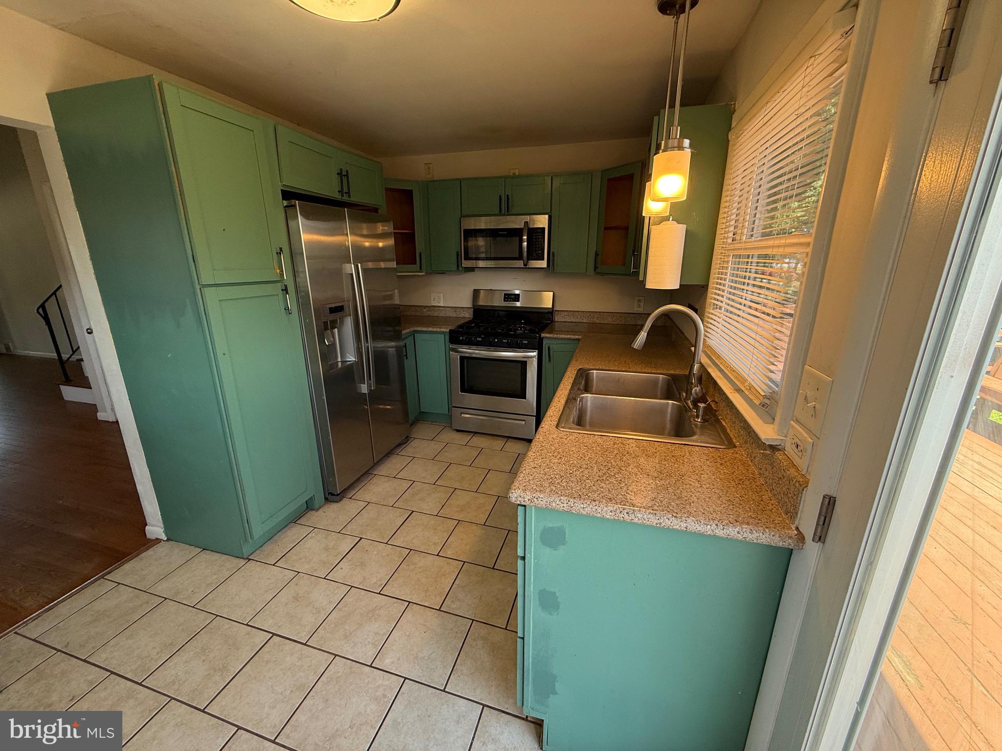 174 Kansas Road Pennsville, NJ 08070 - Photo 10 of 22 a kitchen with stainless steel appliances a refrigerator sink and microwave