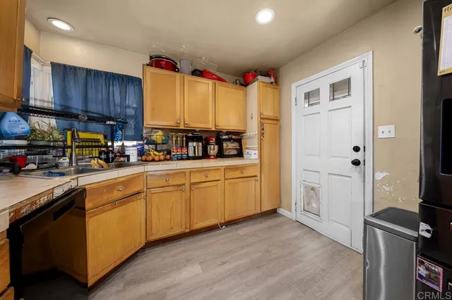 a kitchen with stainless steel appliances a stove sink and cabinets