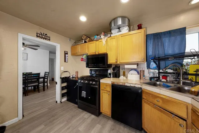 a kitchen with cabinets a sink and appliances