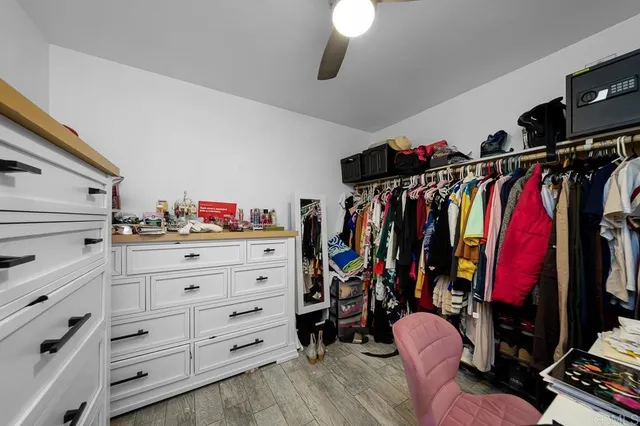 a view of walk in closet with clothes