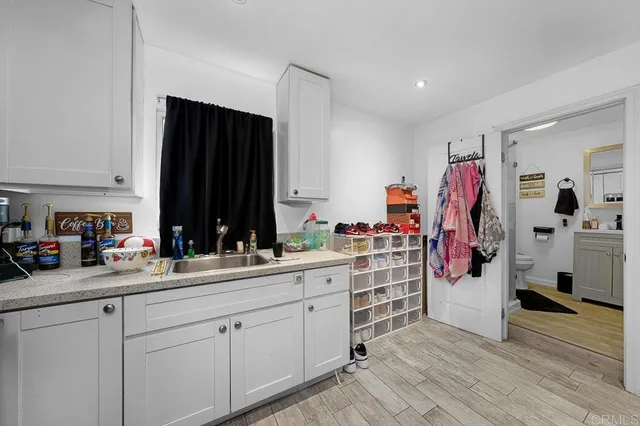 a view of kitchen with cabinets and wooden floor