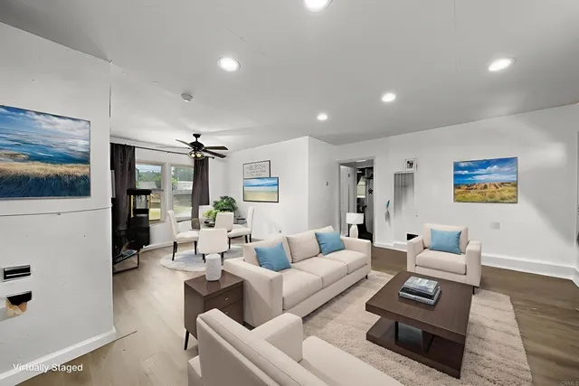 a living room with furniture and wooden floor