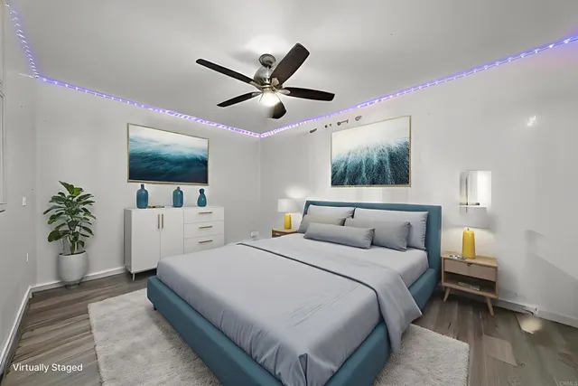 a bedroom with a large bed and a chandelier