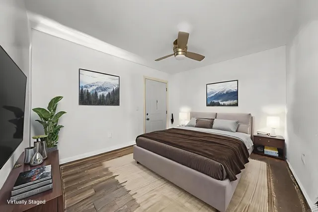 a bedroom with a bed and a potted plant