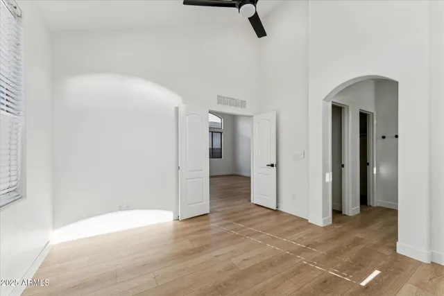 a view of a room with a walk in closet and wooden floor