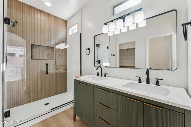 a bathroom with a double vanity sink mirror double and shower
