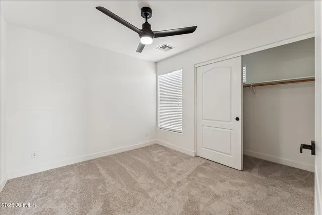 an empty room with a ceiling fan