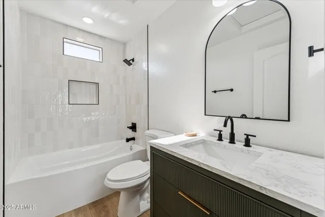 a bathroom with a sink a toilet and a mirror