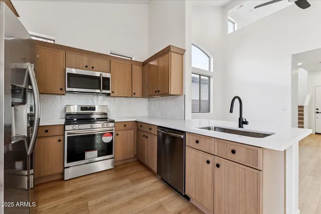a kitchen with stainless steel appliances granite countertop a sink stove and microwave