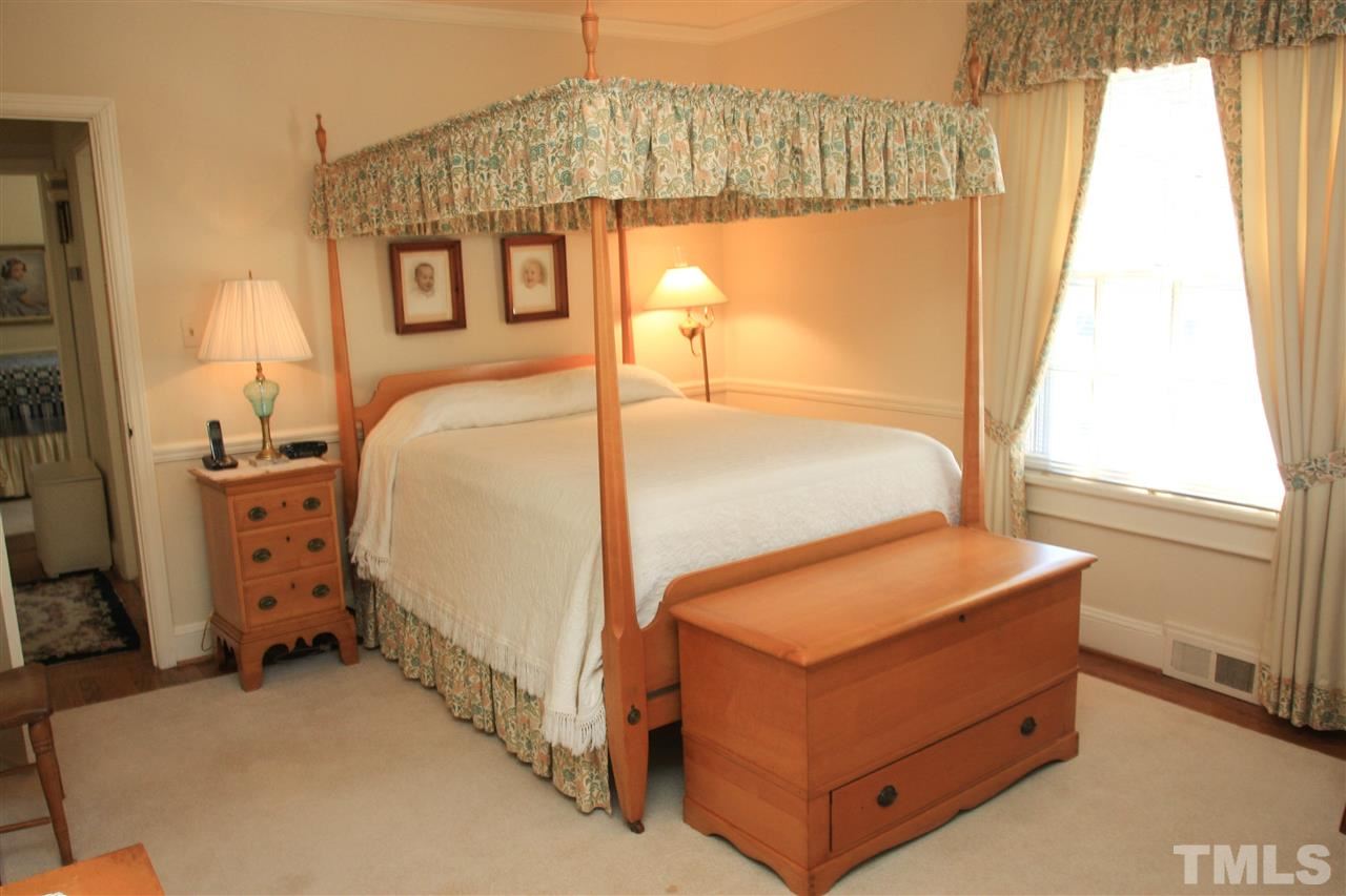 3117 Georgian Terrace Raleigh, NC 27607 - Photo 13 of 25 a bed sitting in a bedroom next to a window