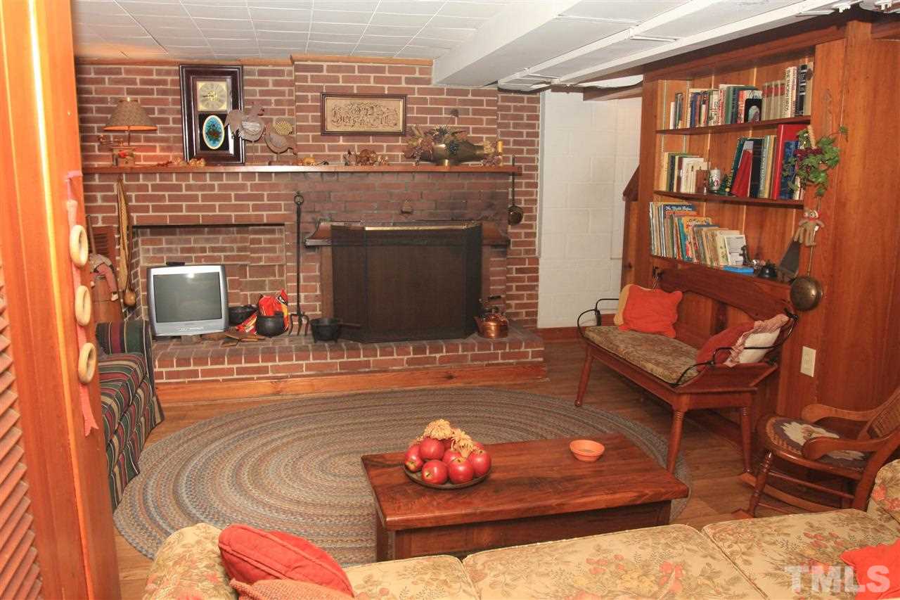 3117 Georgian Terrace Raleigh, NC 27607 - Photo 17 of 25 a living room with furniture and a fireplace