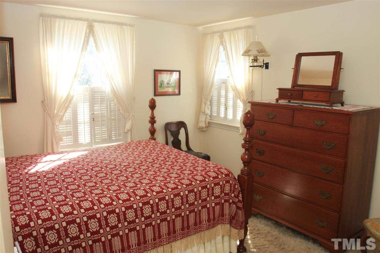 3117 Georgian Terrace Raleigh, NC 27607 - Photo 19 of 25 a bedroom with a bed and wooden floor