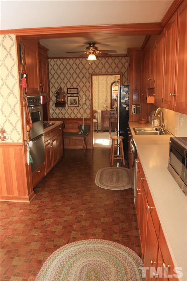 3117 Georgian Terrace Raleigh, NC 27607 - Photo 3 of 25 a kitchen with sink refrigerator and stove