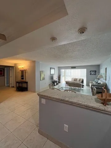 a large kitchen with a sink and cabinets