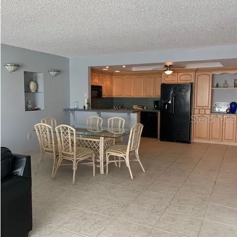 a dining room with furniture and a floor to ceiling window