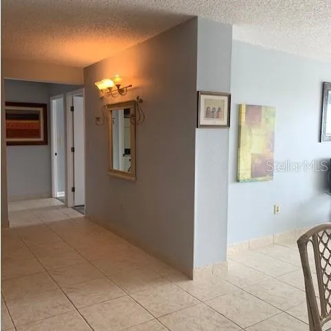 a view of a hallway with paintings on the wall