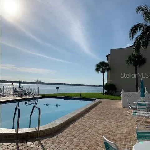 a view of swimming pool with outdoor seating and plants