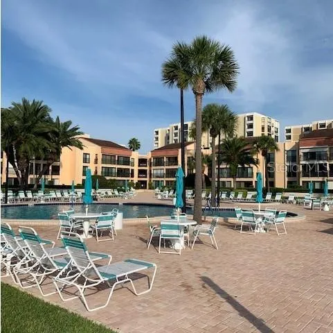a view of a kitchen with kitchen island stainless steel appliances and living room view