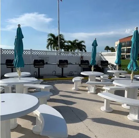 a view of swimming pool with a yard and palm trees