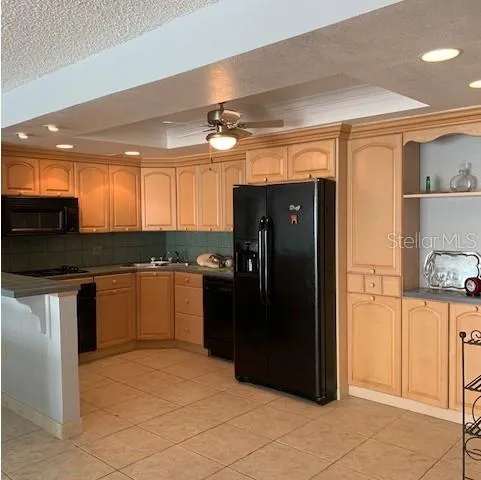 a kitchen with granite countertop a refrigerator and a sink