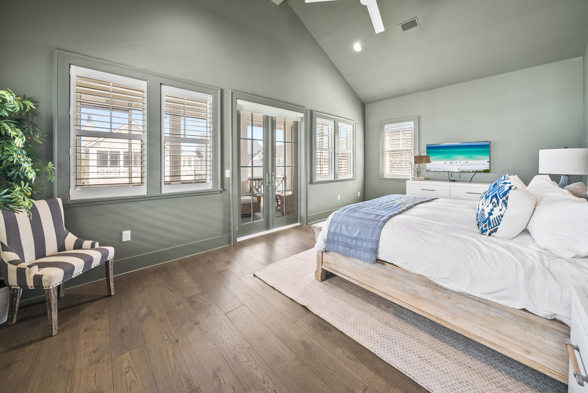 257 Moonlit Way Destin, FL 32541 - Photo 19 of 62 a spacious bedroom with a bed and wooden floor