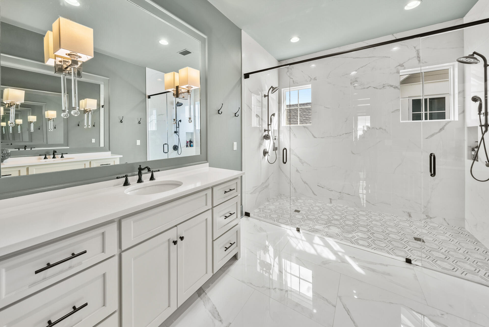 257 Moonlit Way Destin, FL 32541 - Photo 25 of 62 a bathroom with a shower sink and mirror