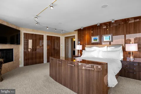 a spacious bedroom with a large bed and a large window