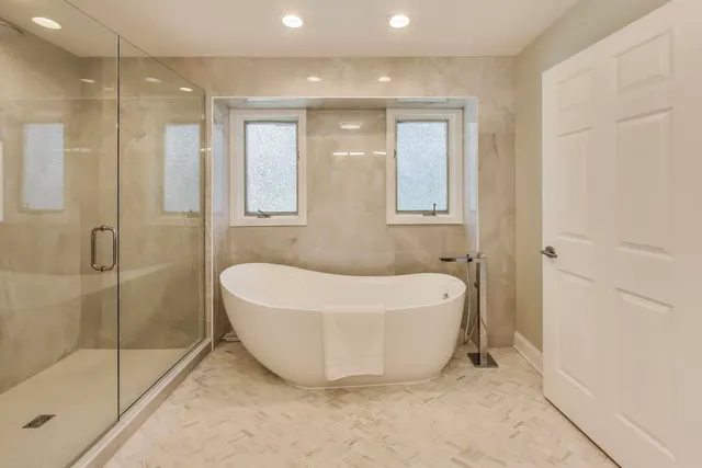 a bathroom with a bathtub and shower