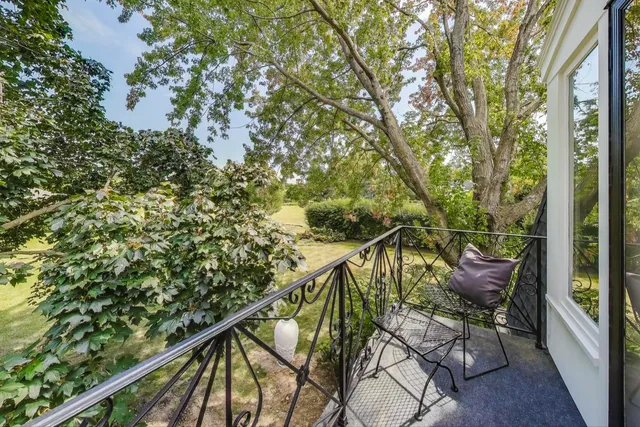 a balcony with table and chairs